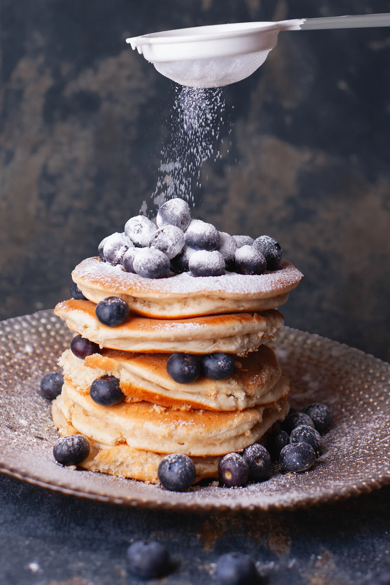 Photograph of pancakes piled high with blueberries - Food photographer in Swindon. Dessert photography
