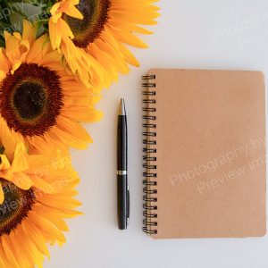 Business stock image preview from Photography by Fran - notebook & pen with sunflowers from above on white