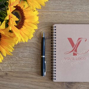 Business stock image preview from Photography by Fran - notebook & pen with sunflowers from above with bespoke logo